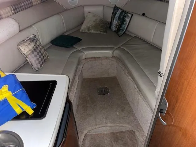 Slide: The Image of Interior cabin of a 2000 Chaparral 240 Signature boat with seating and pillows. - 8