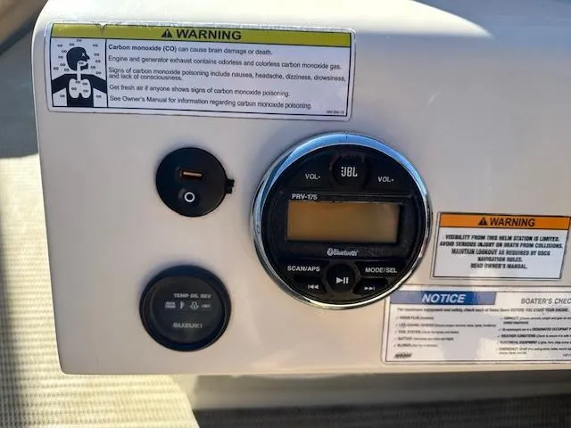 Slide: The Image of Control panel of a 2018 Lexington 325 boat with JBL Bluetooth stereo and warning labels. - 10
