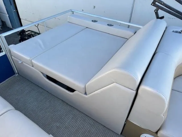 Slide: The Image of 2018 Lexington 325 boat with beige cushioned seating and cup holders. - 6