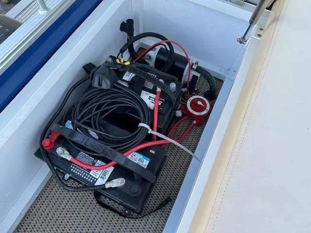 Slide: The Image of Battery compartment of a 2018 Lexington 325 boat with wiring and connections. - 9