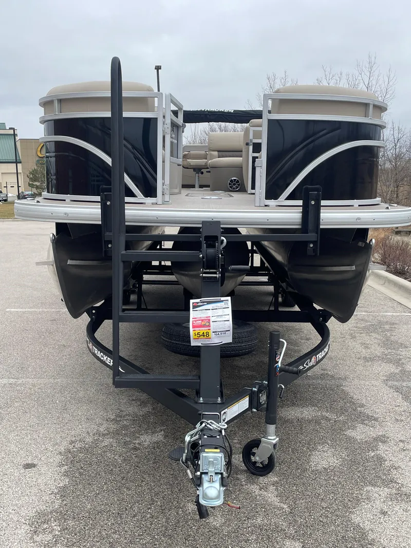 Slide: The Image of 2024 Sun Tracker SportFish 22 XP3 pontoon boat on a trailer. - 2