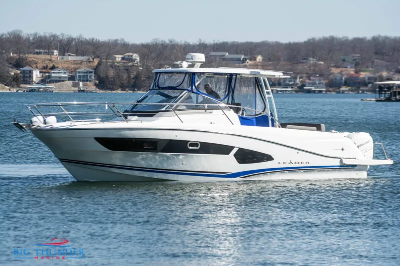 Slide: The Image of 2020 Jeanneau Leader 10.5 boat cruising on a lake. - 10