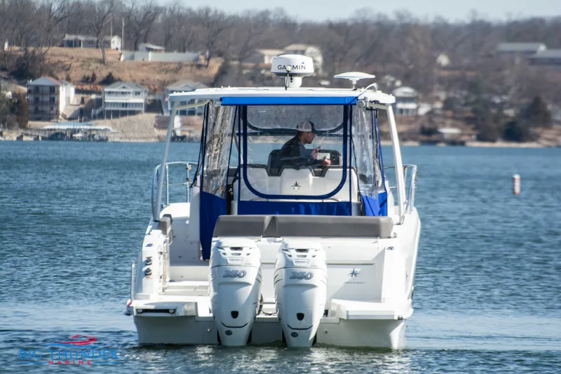 Slide: The Image of 2020 Jeanneau Leader 10.5 boat on a lake with dual outboard engines. - 17