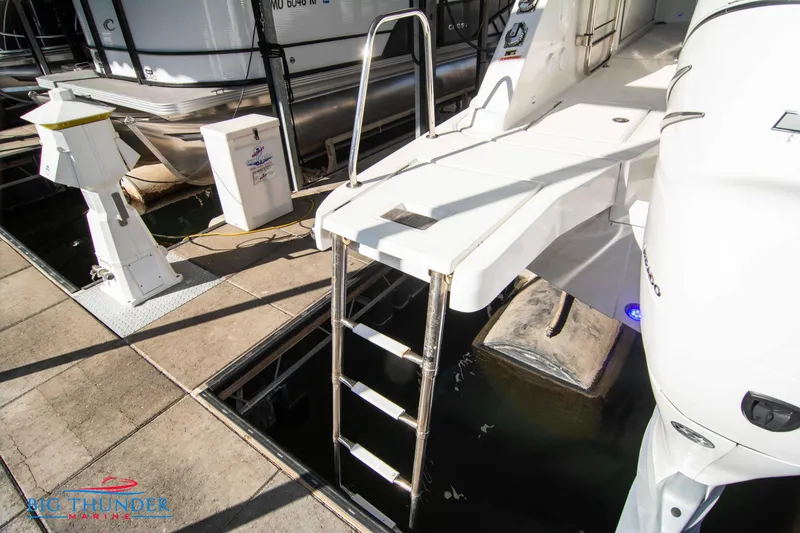 Slide: The Image of Jeanneau Leader 10.5 2020 model boat docked with swim ladder and platform. - 26