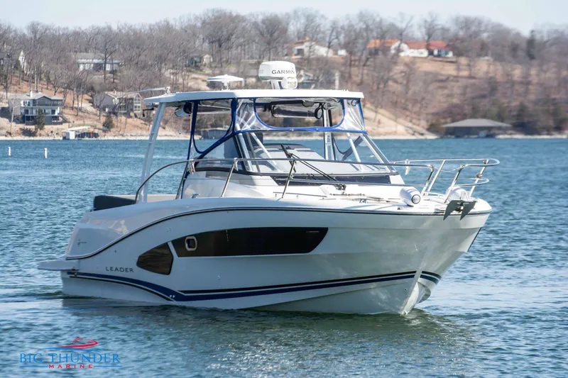 Slide: The Image of 2020 Jeanneau Leader 10.5 boat on a lake near a wooded shoreline. - 3