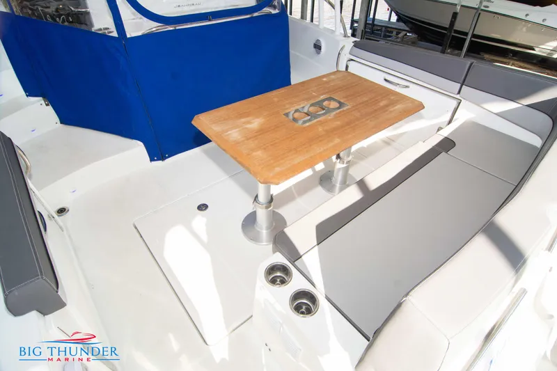 Slide: The Image of Jeanneau Leader 10.5 2020 boat interior with wooden table and seating area. - 33
