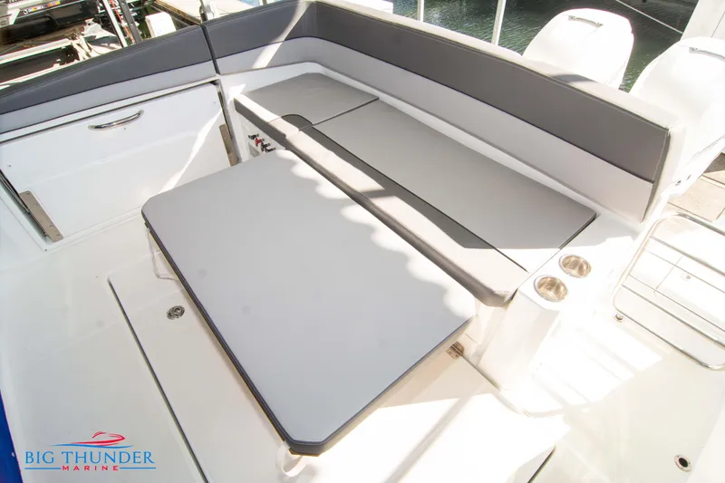 Slide: The Image of 2020 Jeanneau Leader 10.5 boat interior with seating and table. - 35