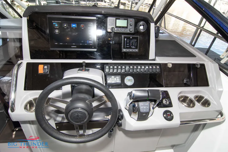 Slide: The Image of Cockpit dashboard of a 2020 Jeanneau Leader 10.5 boat with steering wheel and controls. - 48