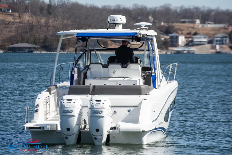 Slide: The Image of 2020 Jeanneau Leader 10.5 boat on a lake with twin outboard engines. - 6