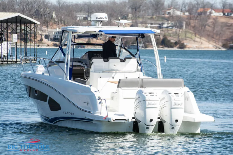 Slide: The Image of 2020 Jeanneau Leader 10.5 boat cruising on a lake with twin outboard engines. - 7