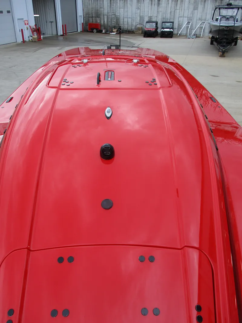 Slide: The Image of 2023 MTI 390XR red powerboat, top view in a marina. - 11