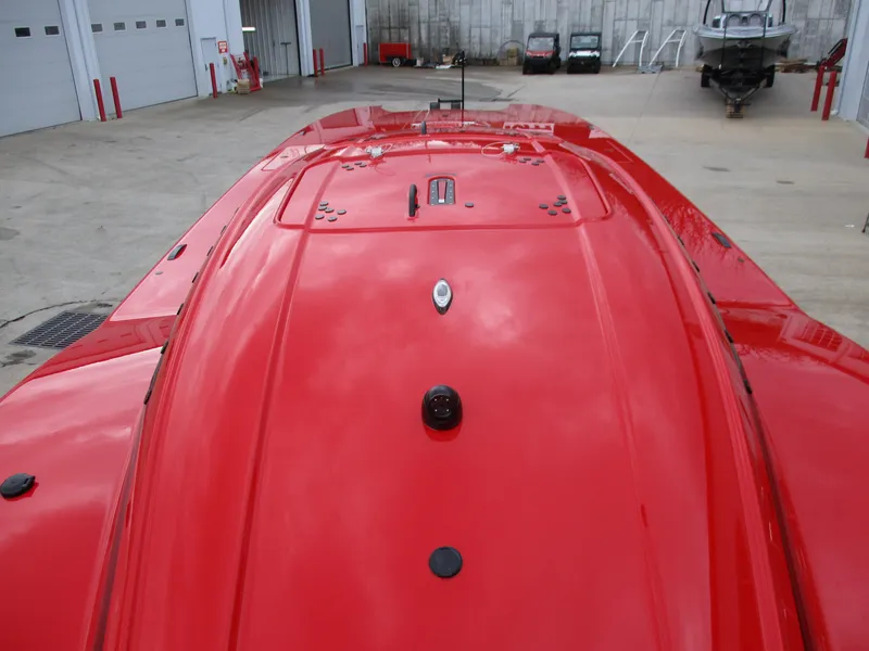 Slide: The Image of 2023 MTI 390XR red boat top view in a garage. - 12