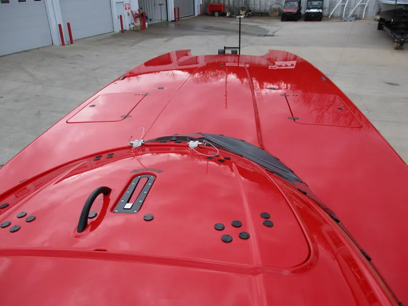 Slide: The Image of 2023 MTI 390XR red boat deck in a warehouse. - 13