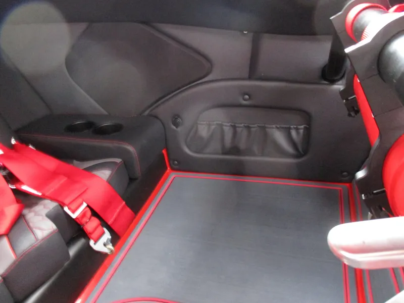 Slide: The Image of Interior of 2023 MTI 390XR boat with red and black seating and safety harness. - 23