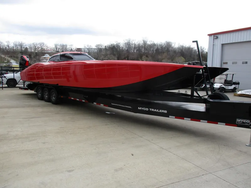Slide: The Image of 2023 MTI 390XR red powerboat on Myco trailer outside warehouse. - 5