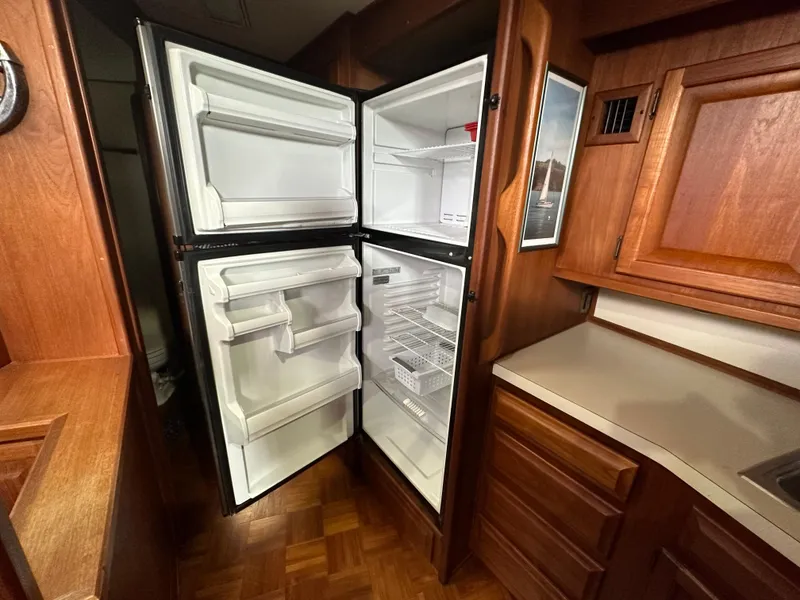 Slide: The Image of Open refrigerator in the kitchen of a 1987 Viking Boats 44 Motor Yacht. - 20