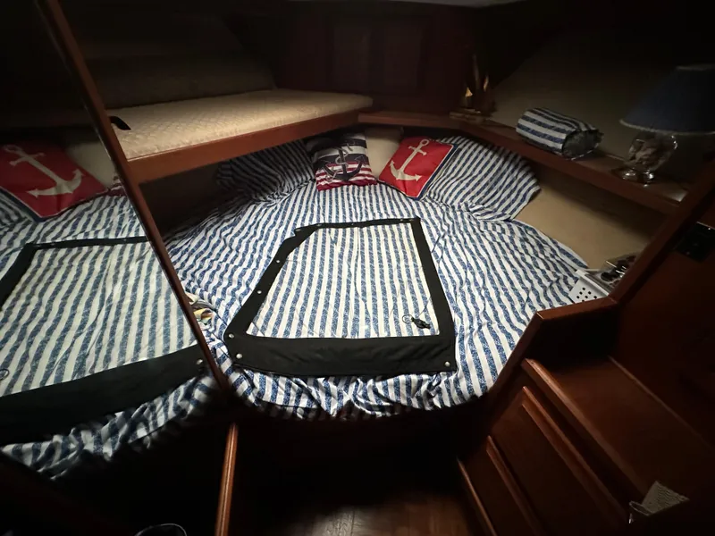Slide: The Image of Cozy cabin interior of 1987 Viking Boats 44 Motor Yacht with striped bedding and nautical decor. - 21