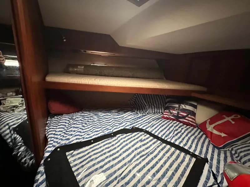 Slide: The Image of Cozy cabin interior of 1987 Viking Boats 44 Motor Yacht with striped bedding. - 22