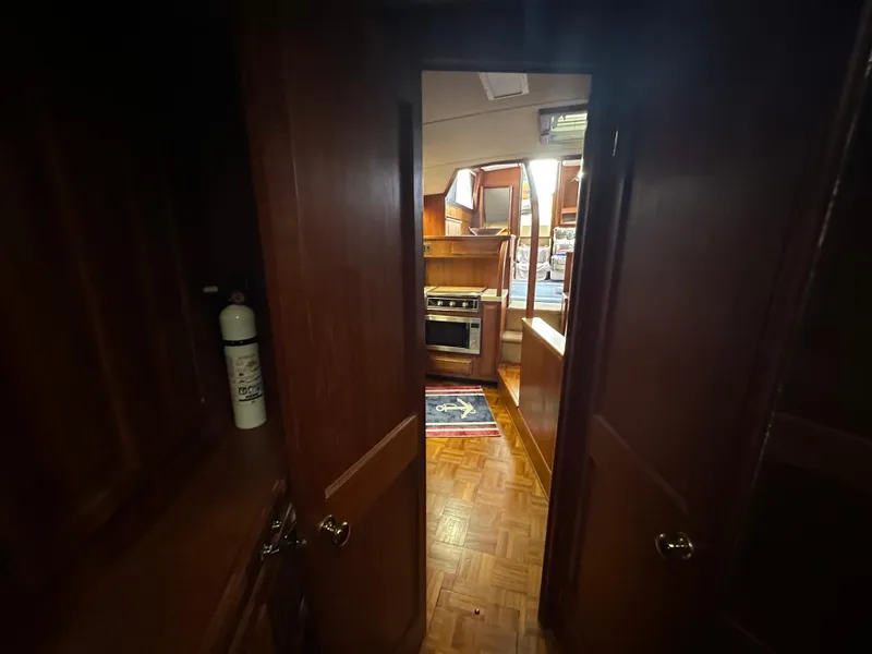 Slide: The Image of 1987 Viking Boats 44 Motor Yacht interior view with kitchen and wooden cabinetry. - 23