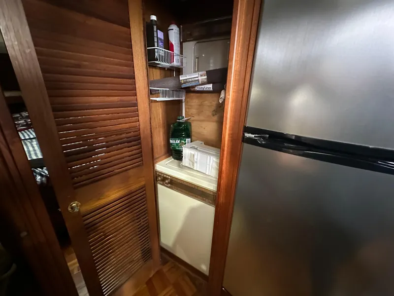 Slide: The Image of Laundry area in 1987 Viking Boats 44 Motor Yacht with washer and storage shelves. - 25