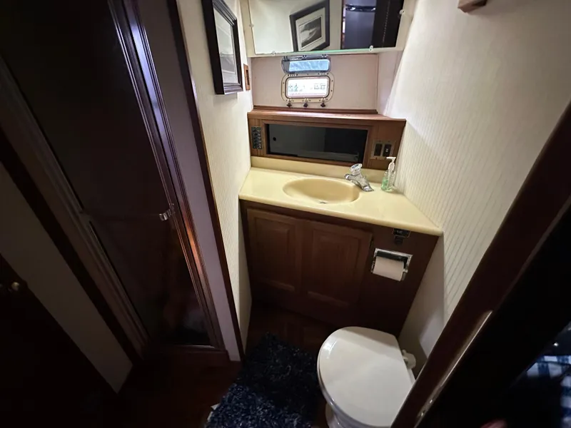 Slide: The Image of 1987 Viking Boats 44 Motor Yacht bathroom with sink, toilet, and shower. - 28