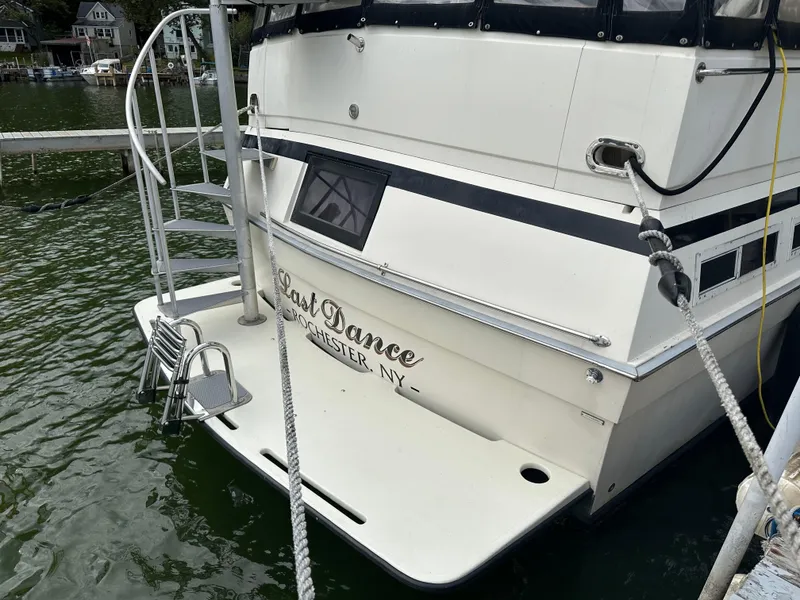 Slide: The Image of 1987 Viking Boats 44 Motor Yacht docked, rear view with Last Dance name. - 3