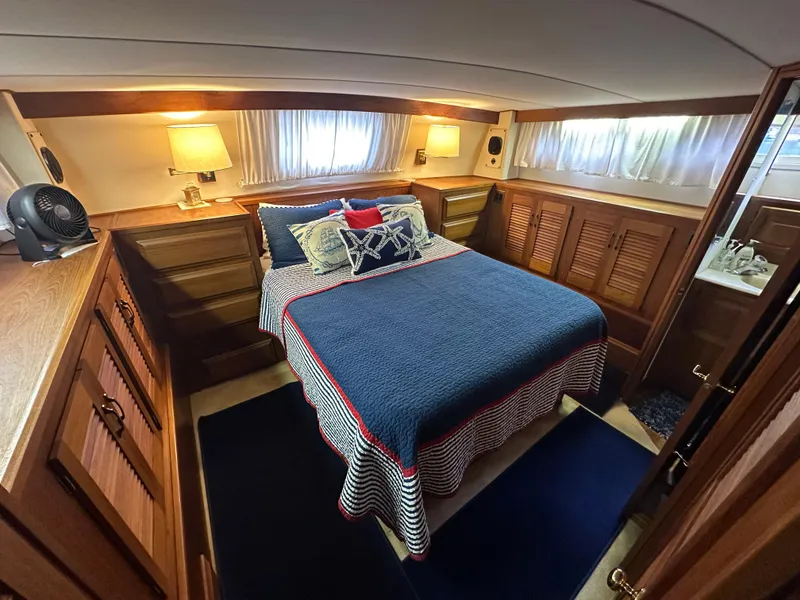Slide: The Image of 1987 Viking Boats 44 Motor Yacht bedroom with cozy bed and wooden cabinetry. - 30