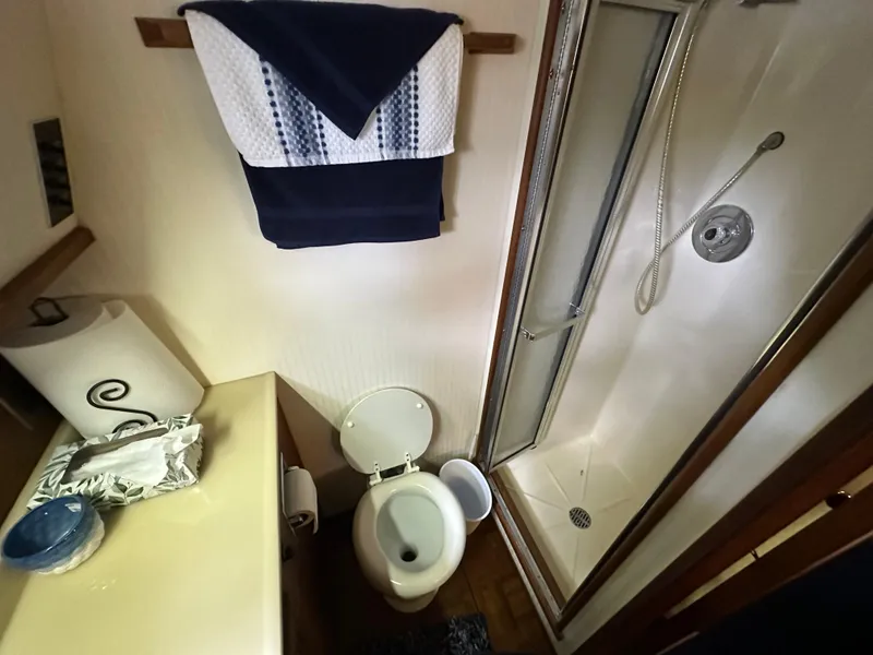 Slide: The Image of 1987 Viking Boats 44 Motor Yacht bathroom with shower, toilet, and sink. - 35