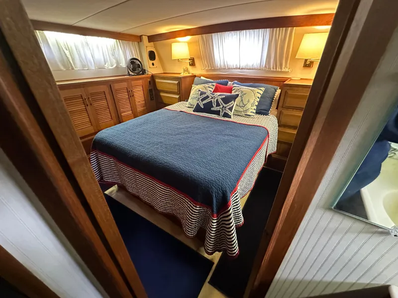 Slide: The Image of 1987 Viking Boats 44 Motor Yacht bedroom with cozy bed and wooden cabinetry. - 37