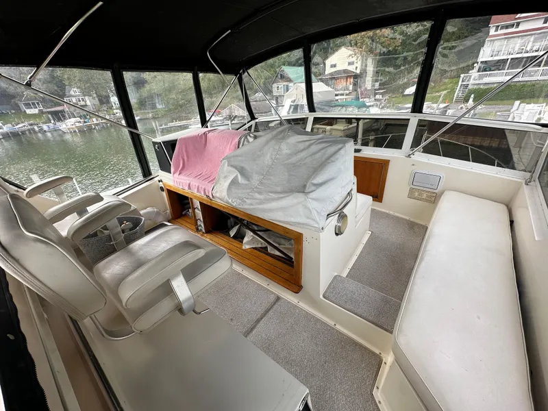 Slide: The Image of 1987 Viking Boats 44 Motor Yacht interior with helm, seating, and covered console. - 42