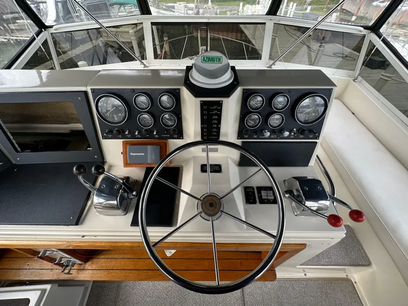 Slide: The Image of 1987 Viking Boats 44 Motor Yacht helm with steering wheel and control panel. - 44