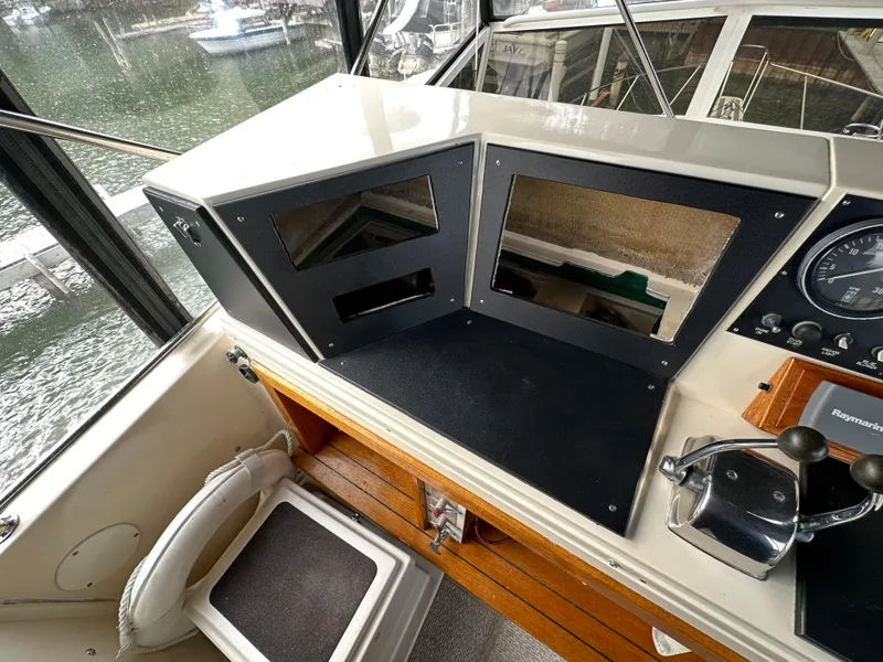 Slide: The Image of 1987 Viking Boats 44 Motor Yacht helm station with control panel and seating. - 45