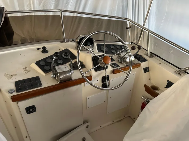Slide: The Image of 1987 Viking Boats 44 Motor Yacht helm with steering wheel and control panel. - 5