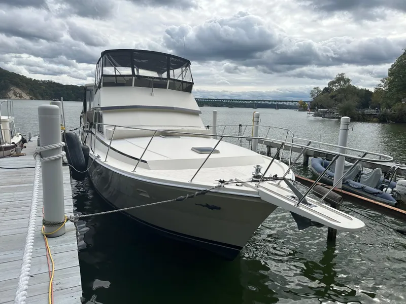 Slide: The Image of 1987 Viking Boats 44 Motor Yacht docked at a marina under cloudy skies. - 6