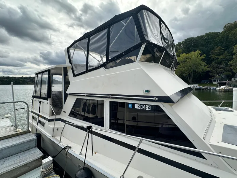 Slide: The Image of 1987 Viking Boats 44 Motor Yacht docked on a cloudy day. - 9