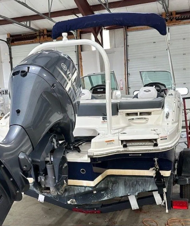 Slide: The Image of 2021 Chaparral 19 SSi boat with outboard motor in a storage facility. - 12