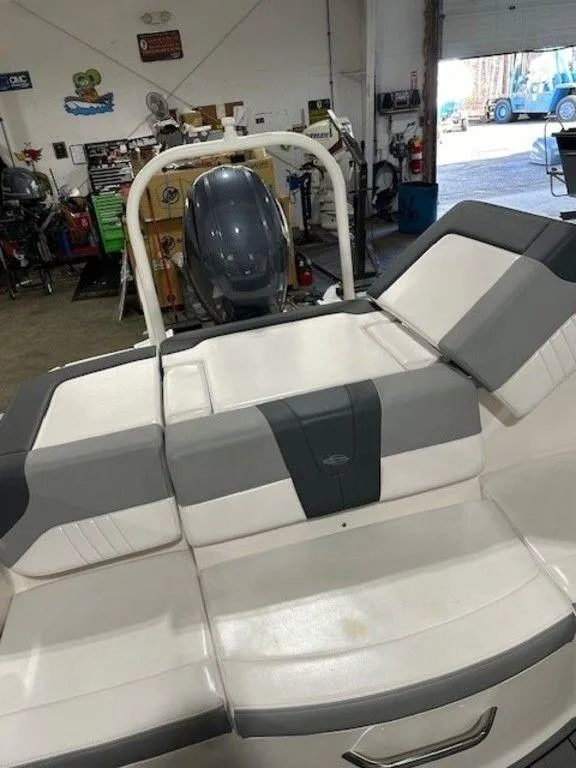 Slide: The Image of 2021 Chaparral 19 SSi boat in a workshop, rear seating and engine visible. - 14