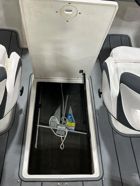 Slide: The Image of 2021 Chaparral 19 SSi boat storage compartment with anchor and rope. - 3