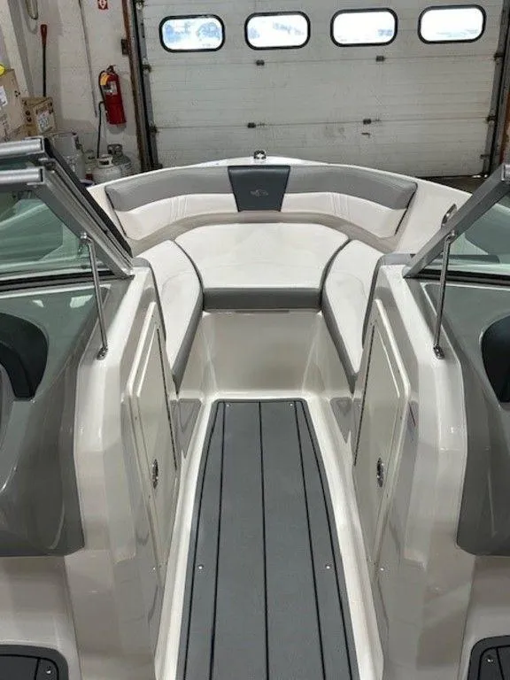 Slide: The Image of 2021 Chaparral 19 SSi boat interior with cushioned seating and gray flooring. - 4