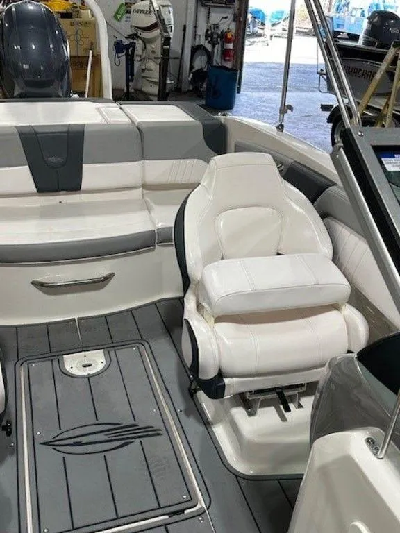 Slide: The Image of 2021 Chaparral 19 SSi boat interior with white seating and gray accents. - 5