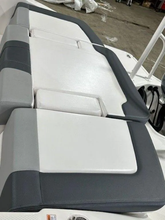 Slide: The Image of 2021 Chaparral 19 SSi boat seating with white and gray upholstery. - 7