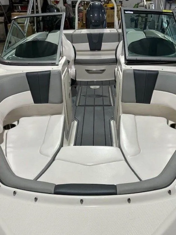 Slide: The Image of 2021 Chaparral 19 SSi boat interior with white and gray seating. - 9