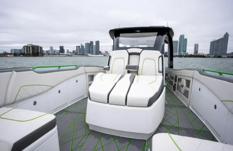 Slide: The Image of 2024 Deep Impact 399 Sport boat with sleek design and city skyline. - 15