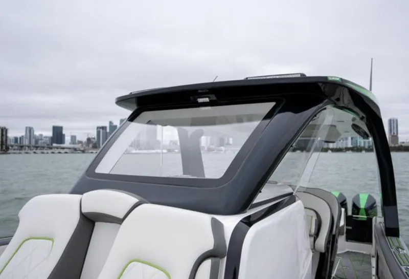 Slide: The Image of 2024 Deep Impact 399 Sport boat on calm water with city skyline. - 17
