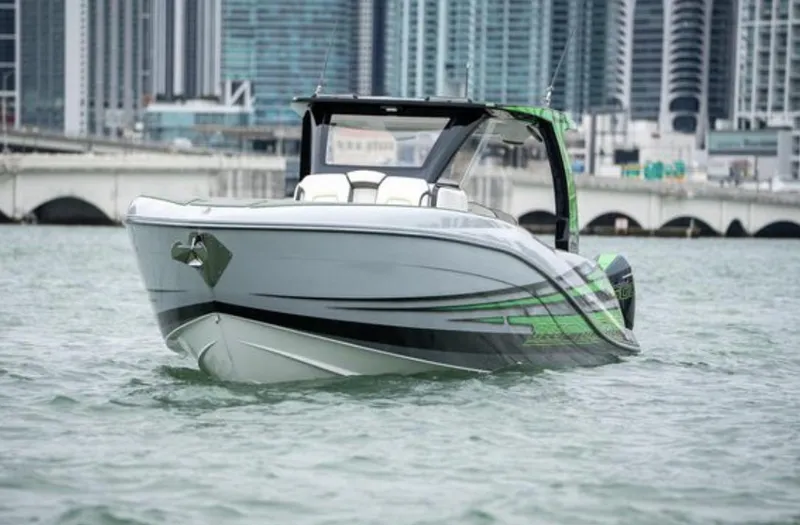 Slide: The Image of 2024 Deep Impact 399 Sport boat on water with city skyline. - 6