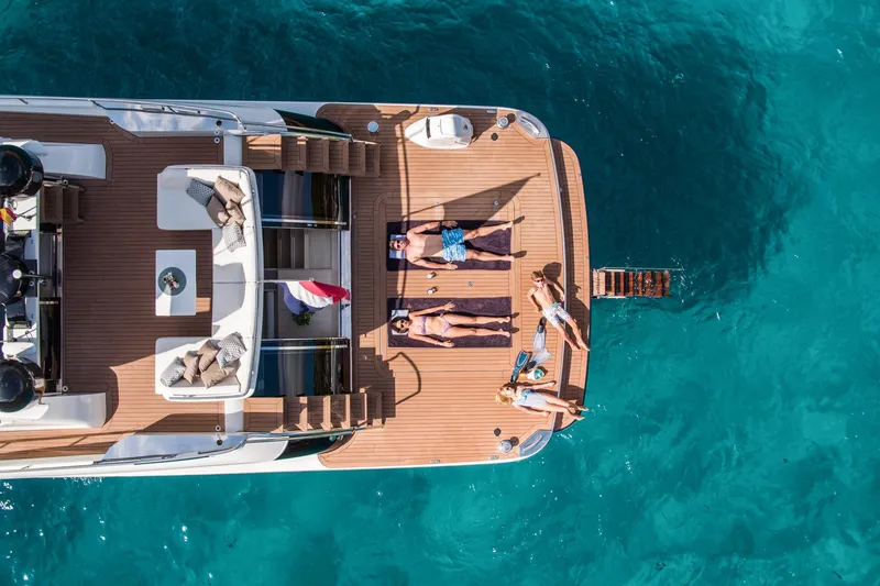 Slide: The Image of Aerial view of 2025 Van der Valk BeachClub 660 Flybridge yacht with people sunbathing. - 11