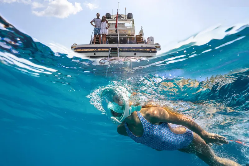 Slide: The Image of Person snorkeling near Van der Valk BeachClub 660 Flybridge yacht, 2025 model, in clear blue water. - 7