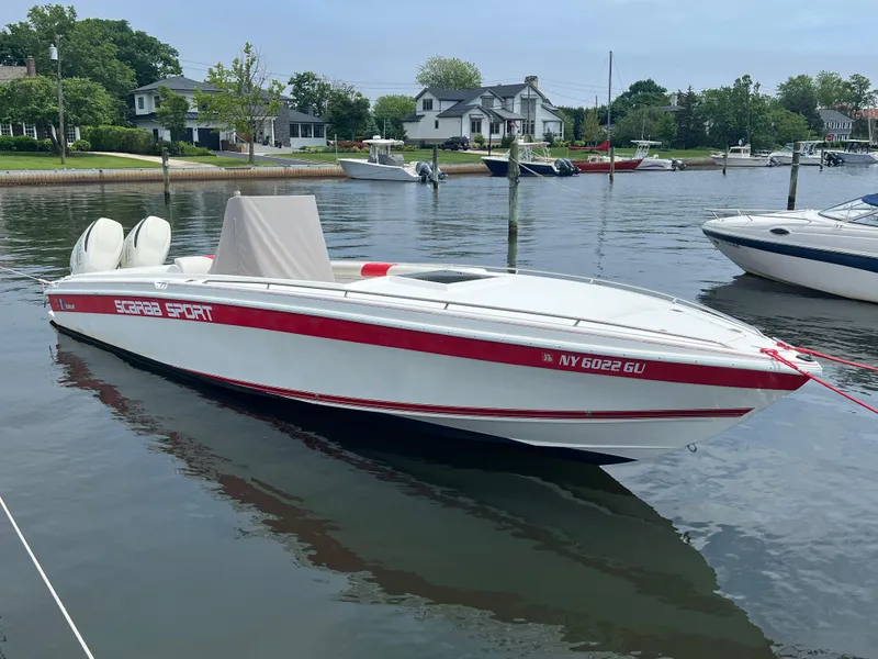 The Image of 1994 Wellcraft 302 SCARAB SPORT boat docked in a serene marina setting. - 0