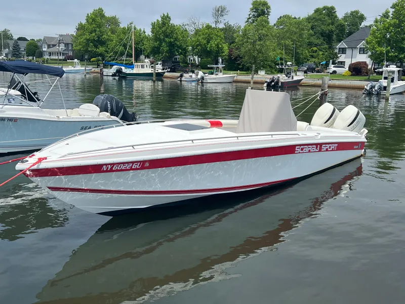 Slide: The Image of 1994 Wellcraft 302 Scarab Sport boat with Suzuki 250 engines docked in a marina. - 1