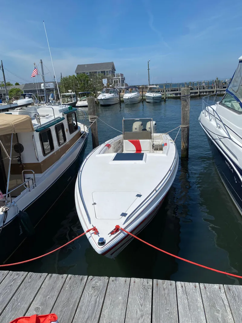 Slide: The Image of 1994 Wellcraft 302 Scarab Sport boat docked at marina with clear blue sky. - 12